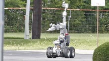  Police use a robot to gain access to the suspects armoured van, which authorities believed was rigged with explosives.