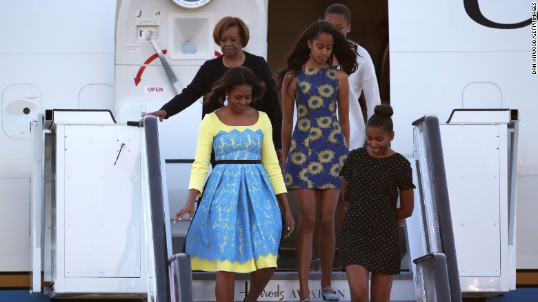 First Lady Michelle Obama arrives with daughters Malia Obama (C) and Sasha Obama (R) and her mother Marian Robinson at Stanstead airport on June 15, 2015 in London, England. During the visit has met with students at a girl&#39;s school to discuss how the UK and U.S. are working together to expand girl&#39;s education around the world.