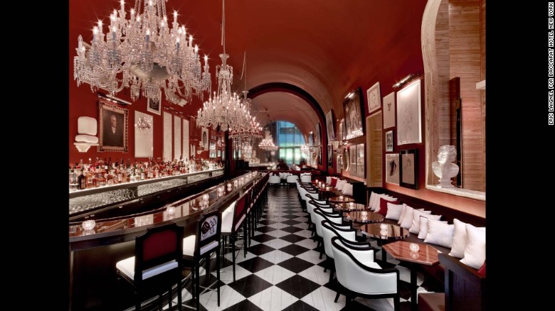 The Bar at Baccarat displays a range of works salon-style on its rich red walls. 