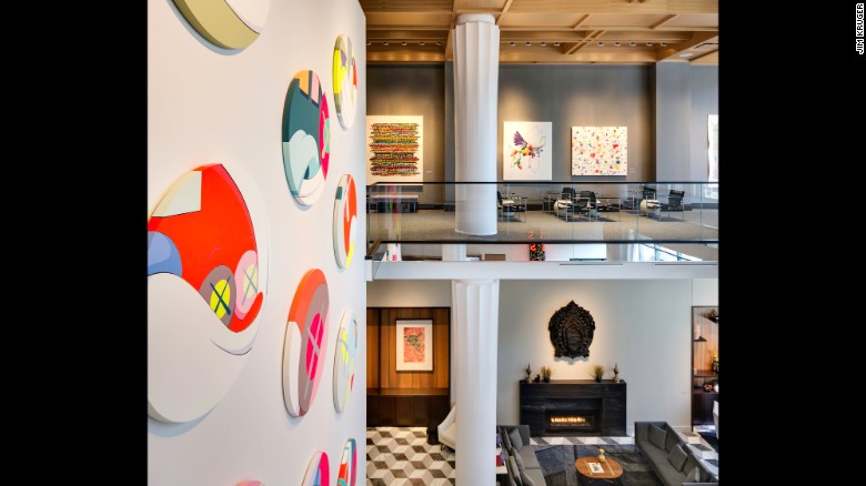 &quot;NYT&quot; (left) is a 12-part acrylic-on-canvas painting by KAWS (Brian Donnelly). It serves as the focal point for the 35-foot atrium lobby of Le Meridien Columbus, The Joseph.