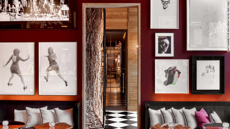 Photographs and work on paper distract visitors from the Baccarat bar&#39;s dazzling chandeliers.