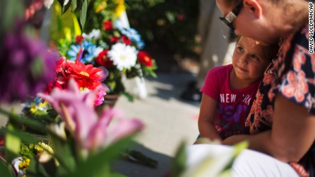Kim Hamby prays with her daughter Kayla as they lay flowers at a makeshift memorial in Charleston on June 18.