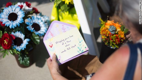 Sandra Bridges lays a card at a memorial on June 18.