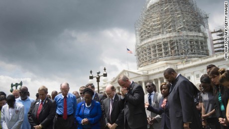 Members of the U.S. Congress gather in front of the Capitol Building in Washington on June 18, during a moment of silence for the nine killed in a church shooting in Charleston, South Carolina.