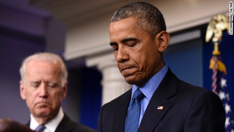 President Barack Obama, accompanied by Vice President Joe Biden, pauses while speaking in the Brady Press Briefing Room of the White House in Washington, June 18, on the church shooting in Charleston. 