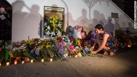 A woman places flowers outside the church on June 18.