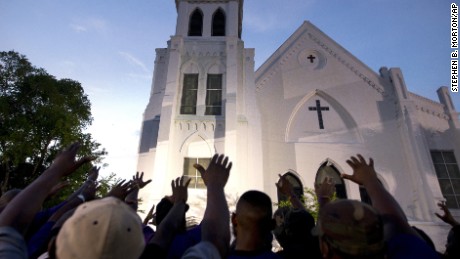 The men of Omega Psi Phi Fraternity lead a prayer outside Emanuel AME Church, Friday, June 19.