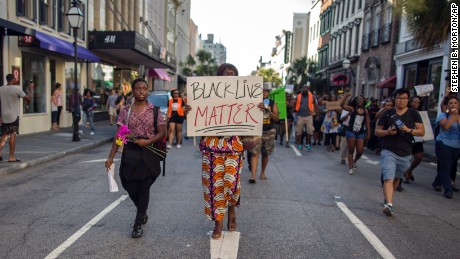 Louise Brown walks down King Street during a "Black Lives Matter" march on June 20 in Charleston, South Carolina. 