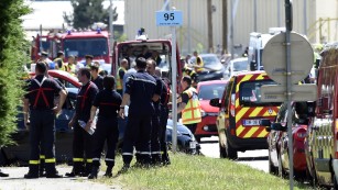 Police and firefighters gather at the entrance of Air Products &amp;amp; Chemicals, a gas factory near Lyon, France, on Friday, June 26, after a terror attack. One person has been beheaded and two people injured, French President François Hollande said Friday. A suspect has been arrested, he said.
