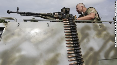 A man with a machine gun is among the Ukrainian troops standing guard in Krimskoe town of Luhansk, Ukraine, on June 25.