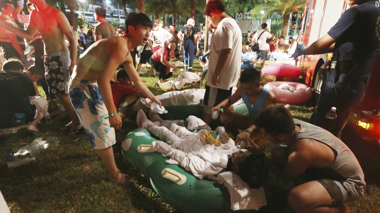 Emergency rescue workers and concert spectators tend to injured victims at the Formosa Water Park in New Taipei City, Taiwan, Saturday, June 27, after flammable powder apparently exploded in mid-air, according to the East Asian nation's official Central News Agency reported.