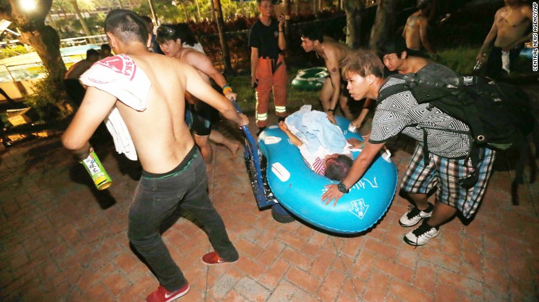 Concert spectators tend to injured victims after an accidental explosion.