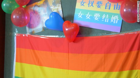 A rainbow flag hangs on the wall at the wedding. On top of it, the slogan reads: &quot;Feminists longs for freedom. Lesbians want to get married.&quot;