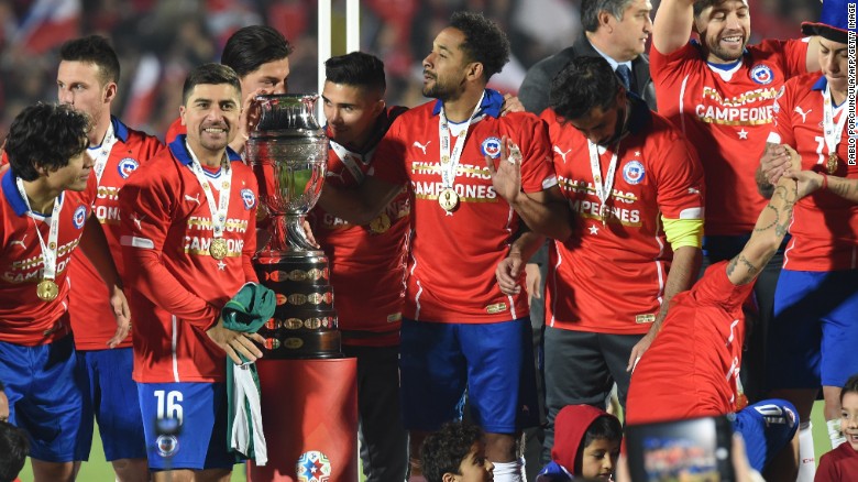 Chile&#39;s players celebrate with the Copa America trophy after being Argentina on penalties in the final in Santiago.