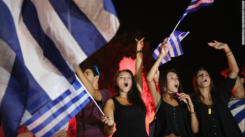 People celebrate in front of the Greek parliament in Athens on Monday after voters rejected a debt bailout by creditors.
