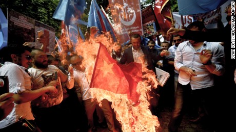 Turkish nationalists burn a Chinese flag, during a protest to denounce China&#39;s treatment of ethnic Uighur Muslims, in front of the Chinese consulate in Istanbul, on July 5, 2015. 