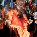 Turkish nationalists burn a Chinese flag, during a protest to denounce China&#39;s treatment of ethnic Uighur Muslims, in front of the Chinese consulate in Istanbul, on July 5, 2015. 