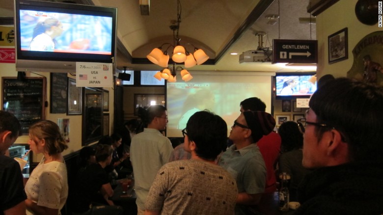 Japanese fans watch the match in a Tokyo bar