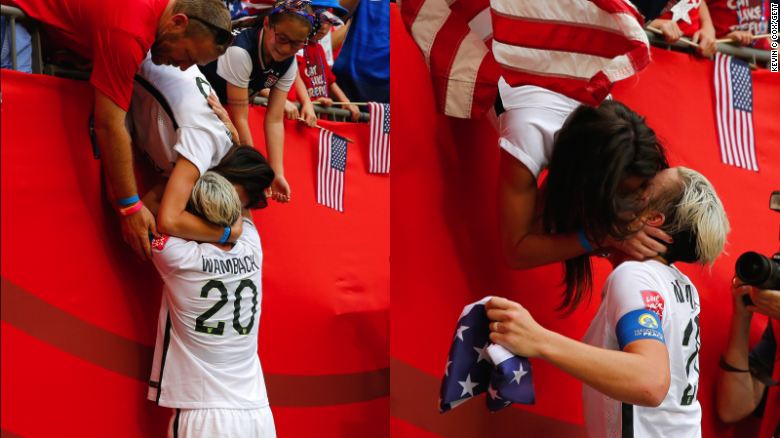 Abby Wambach runs to the stands to kiss her wife, Sarah Huffman.