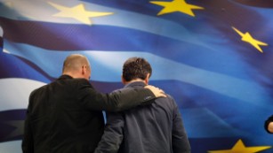 New Greek Finance Minister Euclid Tsakalotos, right, and outgoing Finance Minister Yanis Varoufakis leave together after a hand over ceremony in Athens, Monday, July 6, 2015. Despite triumphing in a popular referendum vote against austerity, Greece on Monday faced the urgent need to heal its ties with European creditors and reach a financial rescue deal that might prevent it from falling out of the euro,  (AP Photo/Petr David Josek)
