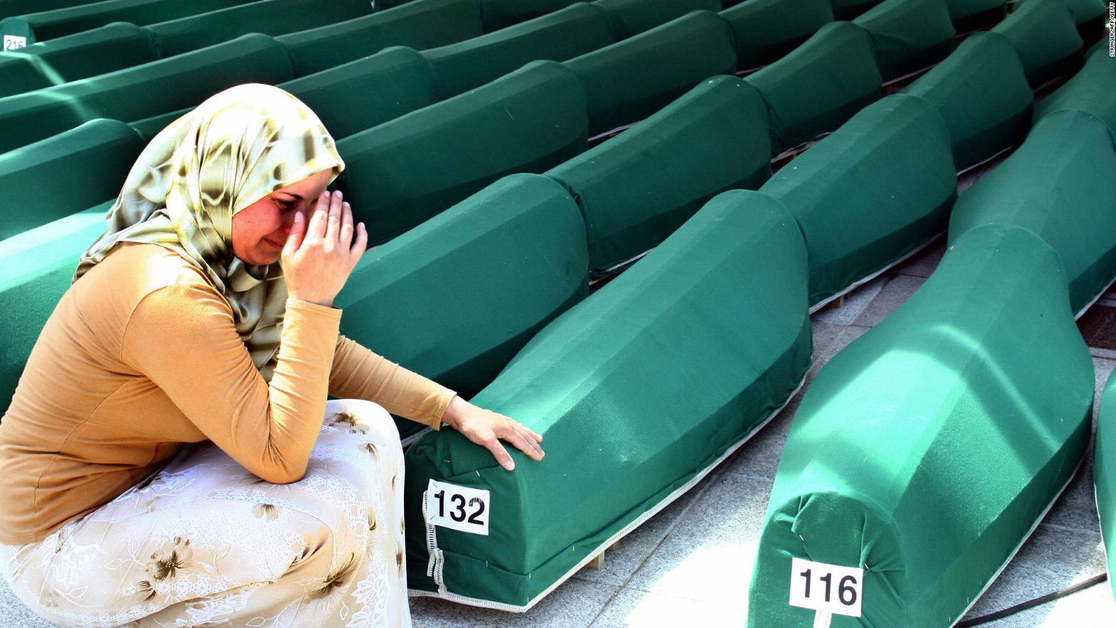 A Bosnian woman weeps next to the coffins of Muslim men and boys before their burial in Potocari, near Srebrenica, East Bosnia and Herzegovina.