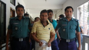 Bangladeshi police escort a suspect in the beating death of a 13-year-old boy in Sylhet.