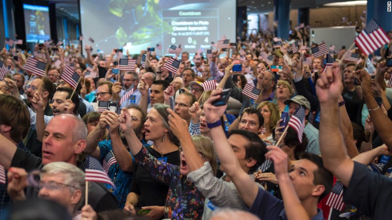 NASA team members and guests count down to the spacecraft&#39;s approach to Pluto on Tuesday, July 14.
