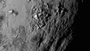  New close-up images of a region near Pluto&#39;s equator reveal a giant surprise: a range of youthful mountains. 