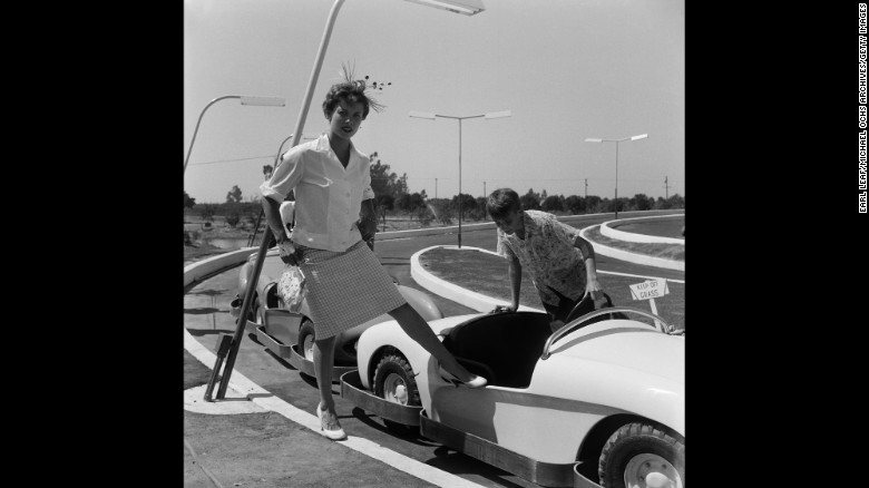 After a $17 million investment and a year of construction on the 160-acre former orange grove, Walt Disney&#39;s biggest gamble was scheduled to open. Actress Adelle August is shown here stepping into the Autopia ride, which was working that day. But little else was in order. Some street asphalt was still soft, paint was still drying and workers were still planting trees. And park officials had underestimated demand: Some 15,000 invitations had been printed for the special day, according to one account, but counterfeiters were at work and crowd estimates went as high as 28,000 visitors. 