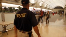 A federal air marshal walks through a check-in area as travelers prepare to board flights at John Wayne Orange County Airport in Santa Ana, Calif., on the 10th anniversary of terrorist attacks on the U.S., Sunday, Sept. 11, 2011. (AP Photo/Reed Saxon/AP)