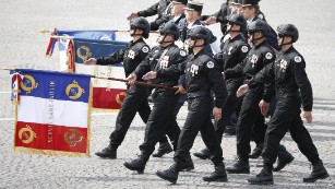 Three Squads of Frances Police elite anti-terror special operations units, the Research, Assistance, Intervention and Dissuasion unit (RAID), the National Gendarmerie Intervention Group (GIGN) and the Research and Intervention Brigade (BRI) march down the Champs Elysees during the annual Bastille Day military parade on July 14, 2015 in Paris