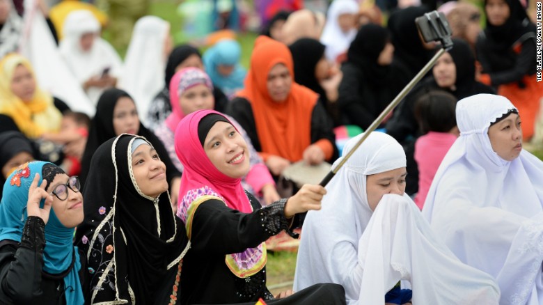 Young Muslims devotees take a &quot;selfie&quot; prior to Friday prayers to mark the end of Ramadan in Manila last year.