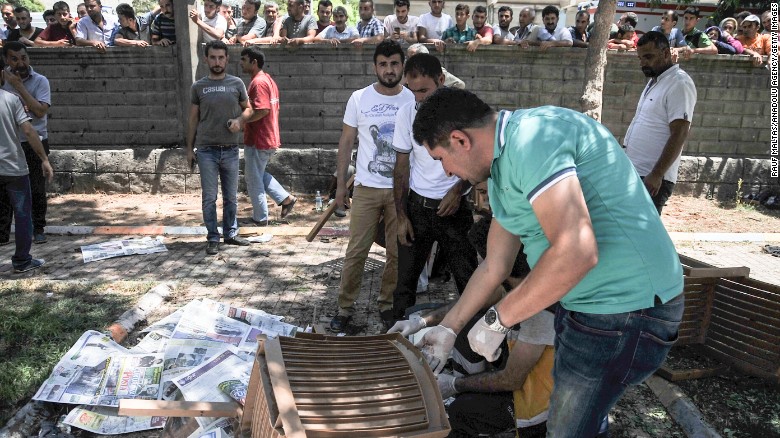 People gather at the site of the explosion July 20. 