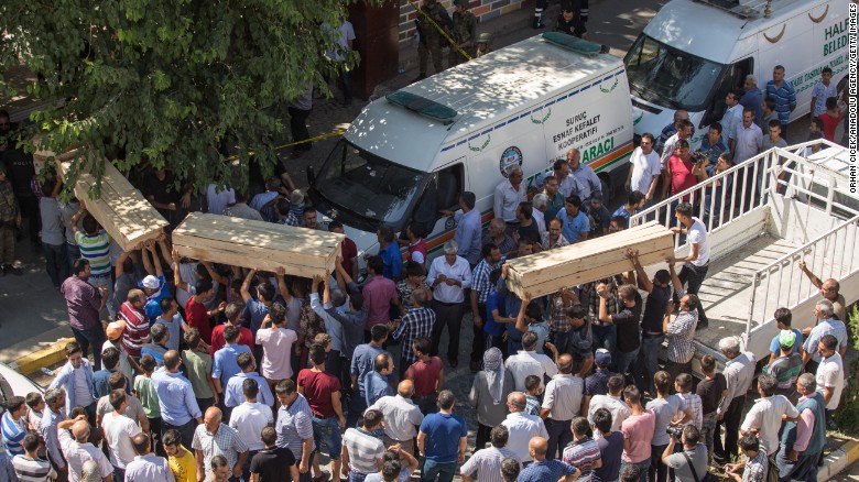 People carry coffins from the scene of an explosion in Suruc, Turkey, on Monday, July 20. More than two dozen people reportedly were killed and 100 others wounded in the town near the Syrian border in what  Turkish officials called a terrorist attack.