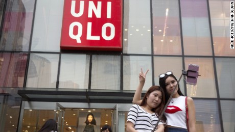 Women take a selfie outside the Uniqlo flagship store in Beijing.