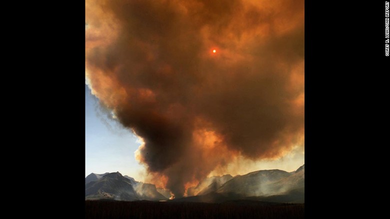 CNN iReporter Corey R. Lewis was visiting Glacier National Park on Monday, July 21, when he saw the fire and shot this picture from the east side of the park. 