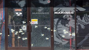 Yellow pieces of paper mark bullet holes in the glass at a military recruiting center on Friday, July 17, 2015, in Chattanooga, Tenn. Muhammad Youssef Abdulazeez of Hixson, Tenn., attacked two military facilities on Thursday, in a shooting rampage that killed four Marines.