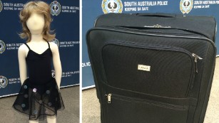 South Australia police display a similar dress and suitcase to ones found near the unidentified girl&#39;s body.