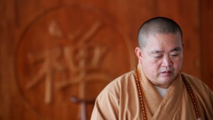 Shi Yongxin, Abbot of the Shaolin Temple, meets visitors on August 24, 2006 in Dengfeng of Henan Province, China. 