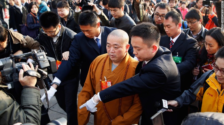 Shi Yongxin (C) Abbot of Shaolin Temple, arrives at The Great Hall Of The People to attend the opening session of the annual National People's Congress at Great Hall of the People on March 5, 2013 in Beijing.