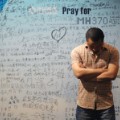 A man stands in front of a billboard in support of missing Malaysia Airlines flight MH370 as Chinese relatives of passengers on the missing Malaysia Airlines flight MH370 have a meeting at the Metro Park Hotel in Beijing on April 23, 2014. The hunt for physical evidence that the Malaysia Airlines jet crashed in the Indian Ocean more than three weeks ago has turned up nothing, despite a massive operation involving seven countries and repeated sightings of suspected debris..      AFP PHOTO / WANG ZHAO        (Photo credit should read WANG ZHAO/AFP/Getty Images)