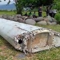 This image taken from video, shows a piece of debris from a plane, Wednesday, July 29, 2015, in Saint-Andre, Reunion. Air safety investigators, one of them a Boeing investigator, have identified the component as a &quot;flaperon&quot; from the trailing edge of a Boeing 777 wing, a U.S. official said. Flight 370, which disappeared March 8, 2014, with 239 people on board, is the only 777 known to be missing. (Reunion 1ere via AP) FRANCE OUT