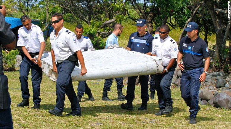 Police carry debris on July 29.