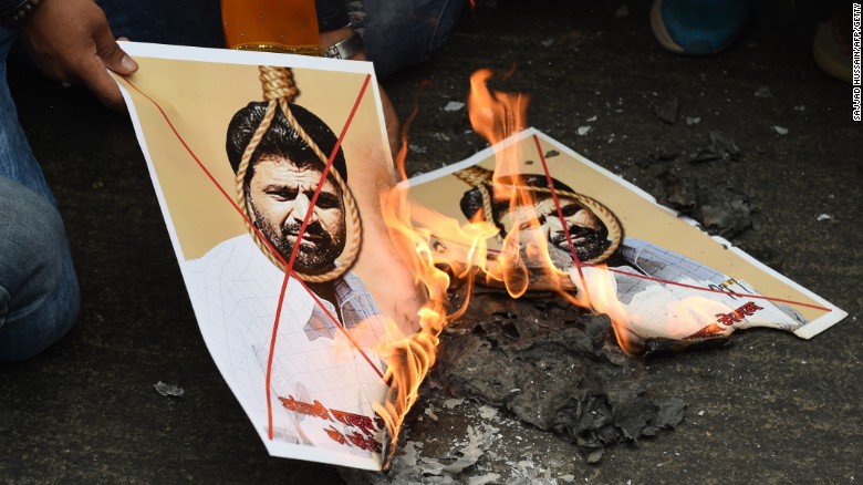 Activists burn photographs of Yakub Memon, convicted of plotting Mumbai bomb attacks which killed hundreds of people in 1993.