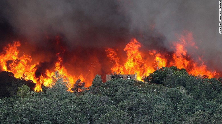 Flames from the Rocky Fire approach a house on Friday,  July 31, in Lower Lake, California.  The fire has burned through 18,000 acres in Lake County as of Friday.  Cal Fire spokesman Daniel Berlant says it has destroyed three homes and led to a mandatory evacuation order for about 500 homes (1,000 people) under threat.