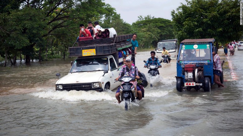 Vehicles make their way through a flooded road in Bago, 50 miles northeast of Yangon, Myanmar, Saturday, Aug 1, 2015.