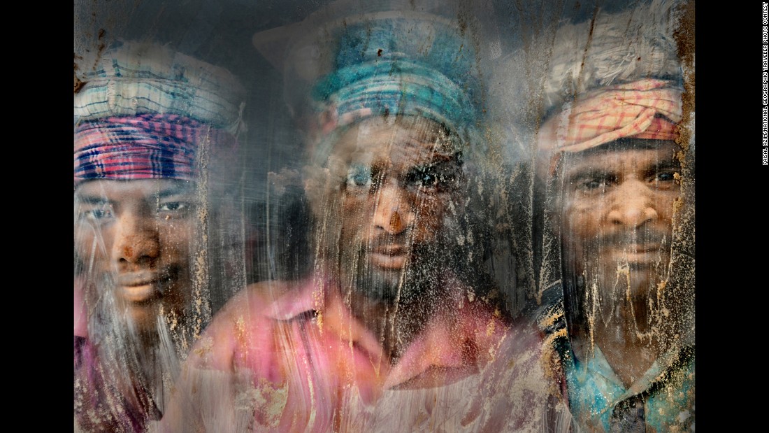 &quot;(This) gravel-crush working place remains full of dust and sand,&quot; Azim said of this photo from Chittagong, Bangladesh. &quot;Three gravel workmen are looking through the window glass at their working place.&quot;