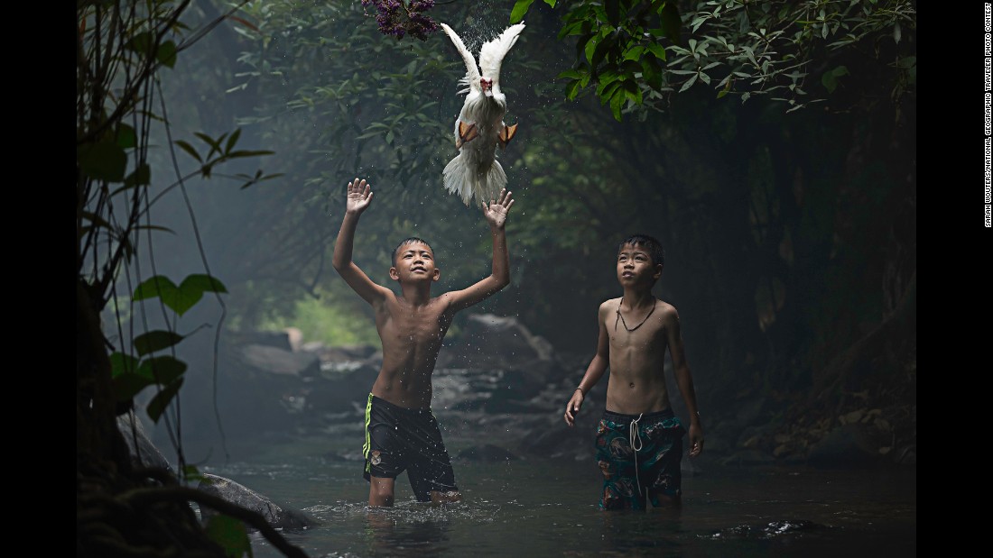 &quot;Two boys are trying to catch a duck at the stream of the waterfall (in) Nong Khai Province, Thailand,&quot; Wouters said.