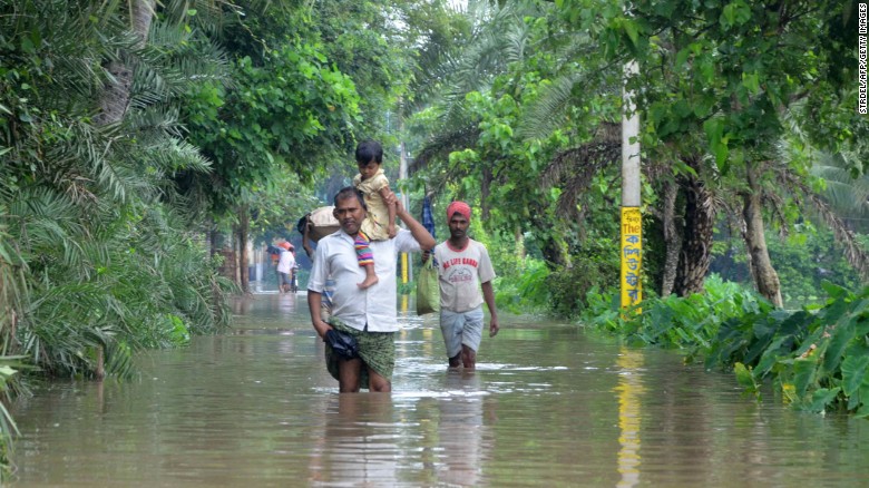 Indian villagers wade through floodwater in Bherampur Block, Murshidabad. In Gujarat, India&#39;s westernmost state, 71 people have died. Another 69 have died in West Bengal and 38 have lost their lives in Rajasthan, according to State Home Ministry Spokesman Kuldeep Dhatwalia.