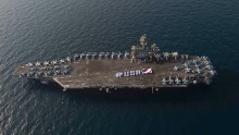 Sailors spell out #USA with the American flag on the flight deck of the Nimitz-class aircraft carrier USS Theodore Roosevelt in the Persian Gulf in late June 2015. When the Roosevelt leaves the Gulf sometime in October, the U.S. Navy will be without a carrier in the important region for two months.